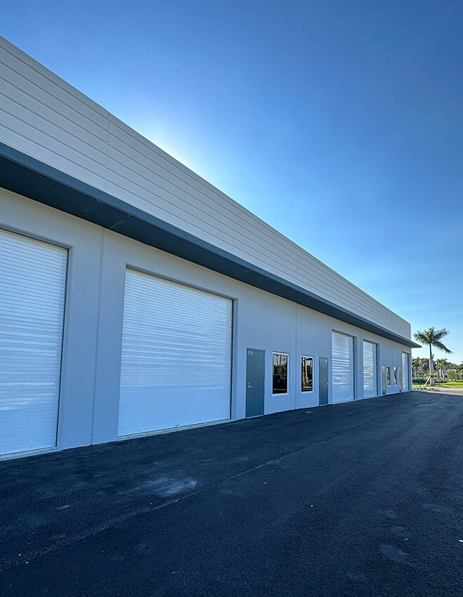 An HEG industrial warehouse. A long white building with large garage bay doors